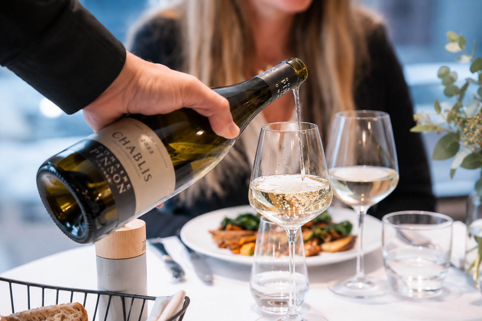 Sommelier pouring wine at the table